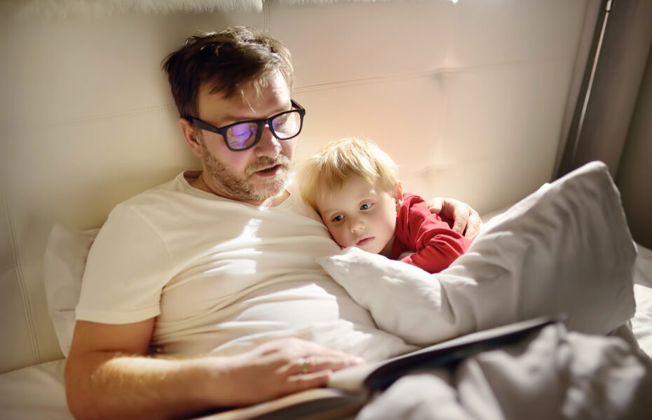 Isä lukee kuvassa pojalleen iltasatua