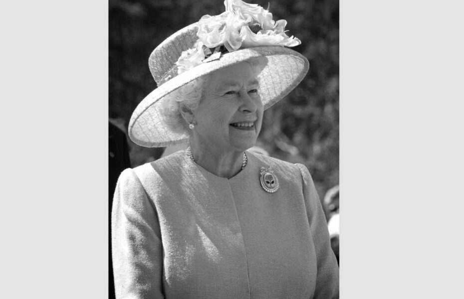 Mustavalkoinen kuva hymyilevästä kuningatar Elisabetista