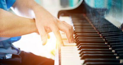 Kädet pianon koskettimilla.