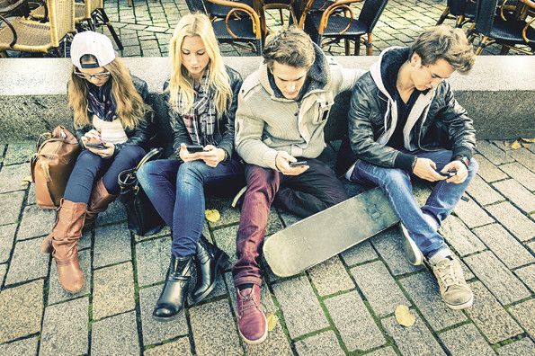 Group of young hipster friends playing with smartphone with mutual disinterest towards each other - Modern situation of technology interaction in alienated lifestyle - Internet wifi connection